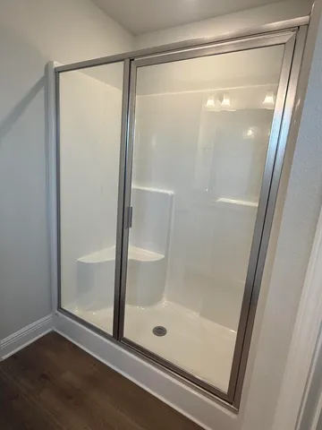 a bathroom with a glass shower door