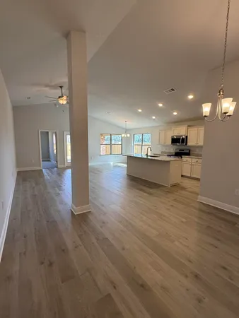 a kitchen with granite countertop a stove top oven and cabinets