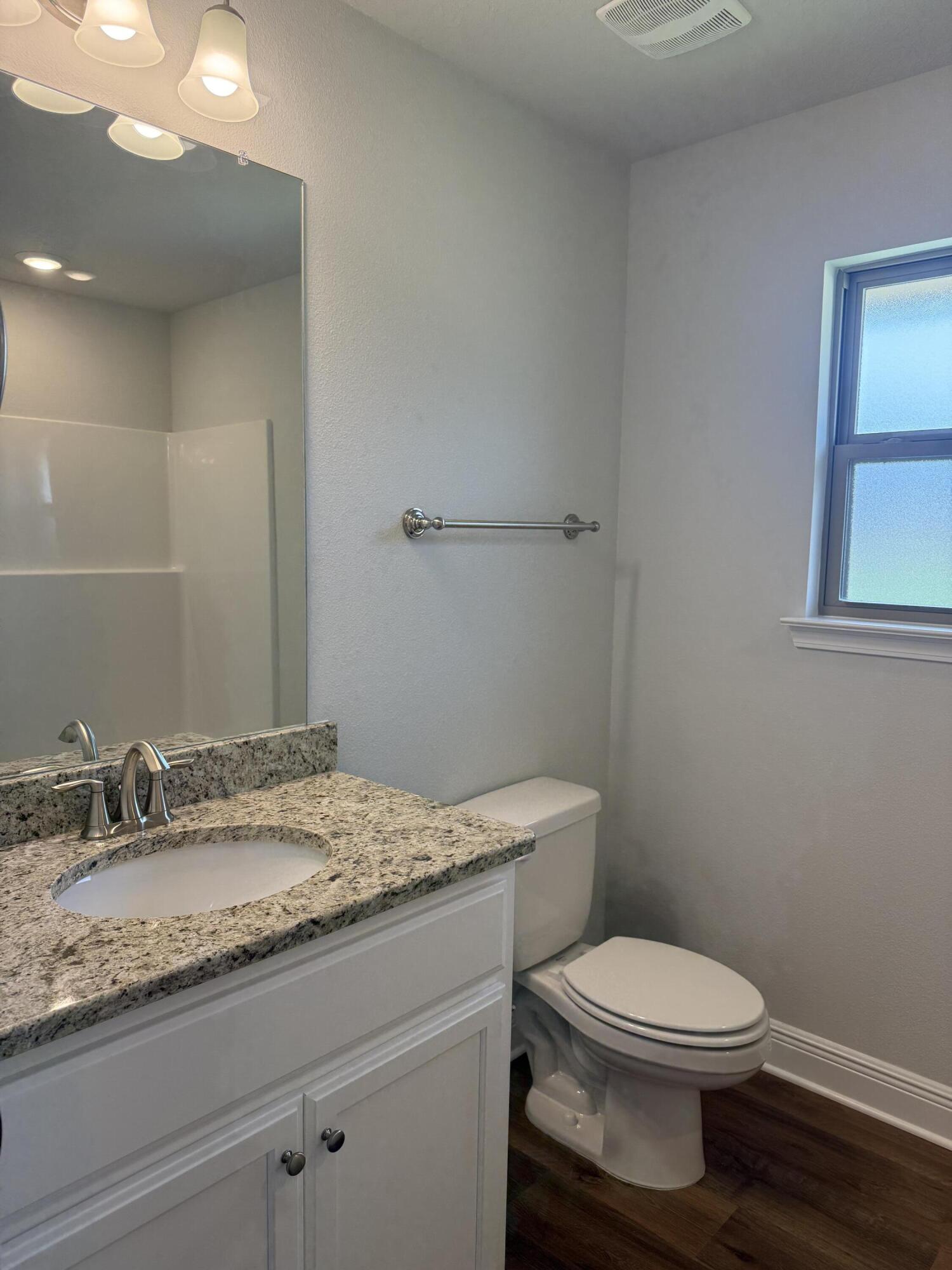 190 Ridgeway Circle Crestview, FL 32536 - Photo 7 of 19 a bathroom with a granite countertop toilet a sink and mirror