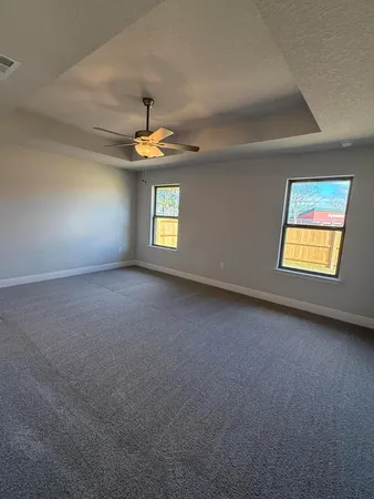 a kitchen with white cabinets and chandelier