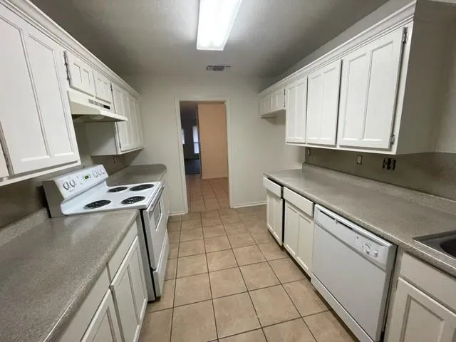 a kitchen with stainless steel appliances granite countertop a sink stove and cabinets