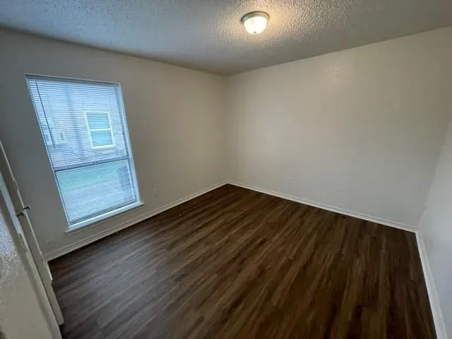 a view of an empty room and wooden floor