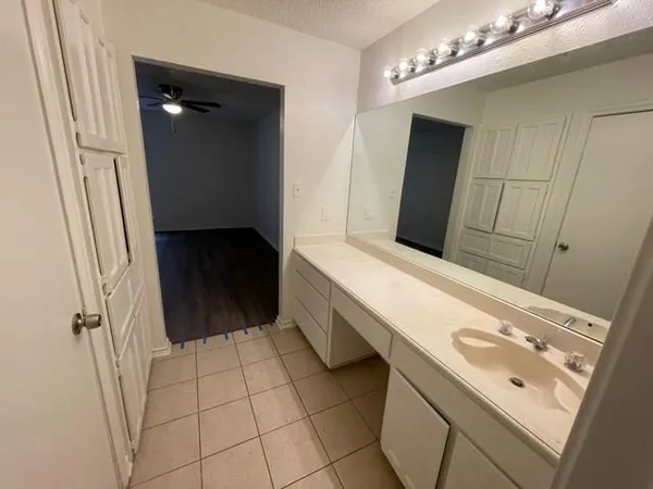 a bathroom with a double vanity sink a toilet and a mirror