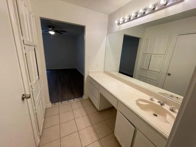 a bathroom with a double vanity sink a toilet and a mirror