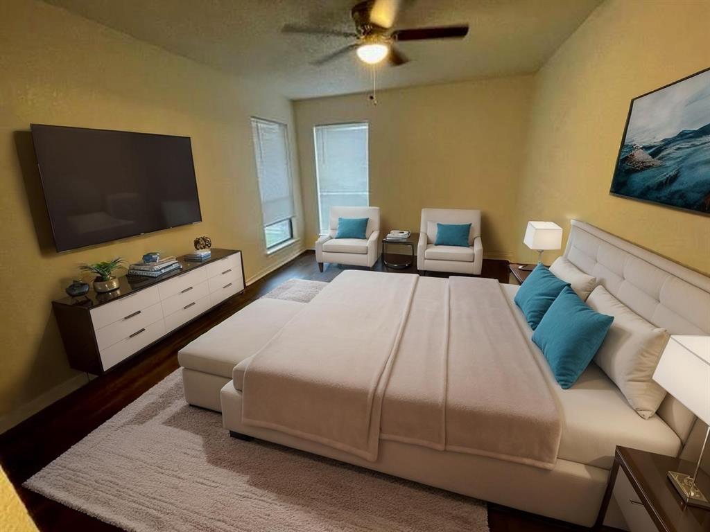 804 Cullum Court, Unit A Hurst, TX 76053 - Photo 22 of 29 a bedroom with a bed and a flat screen tv