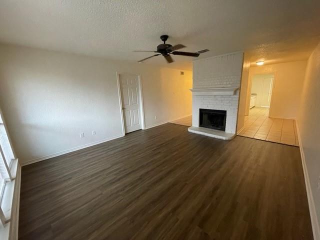 804 Cullum Court, Unit A Hurst, TX 76053 - Photo 9 of 29 a view of empty room with wooden floor and fireplace