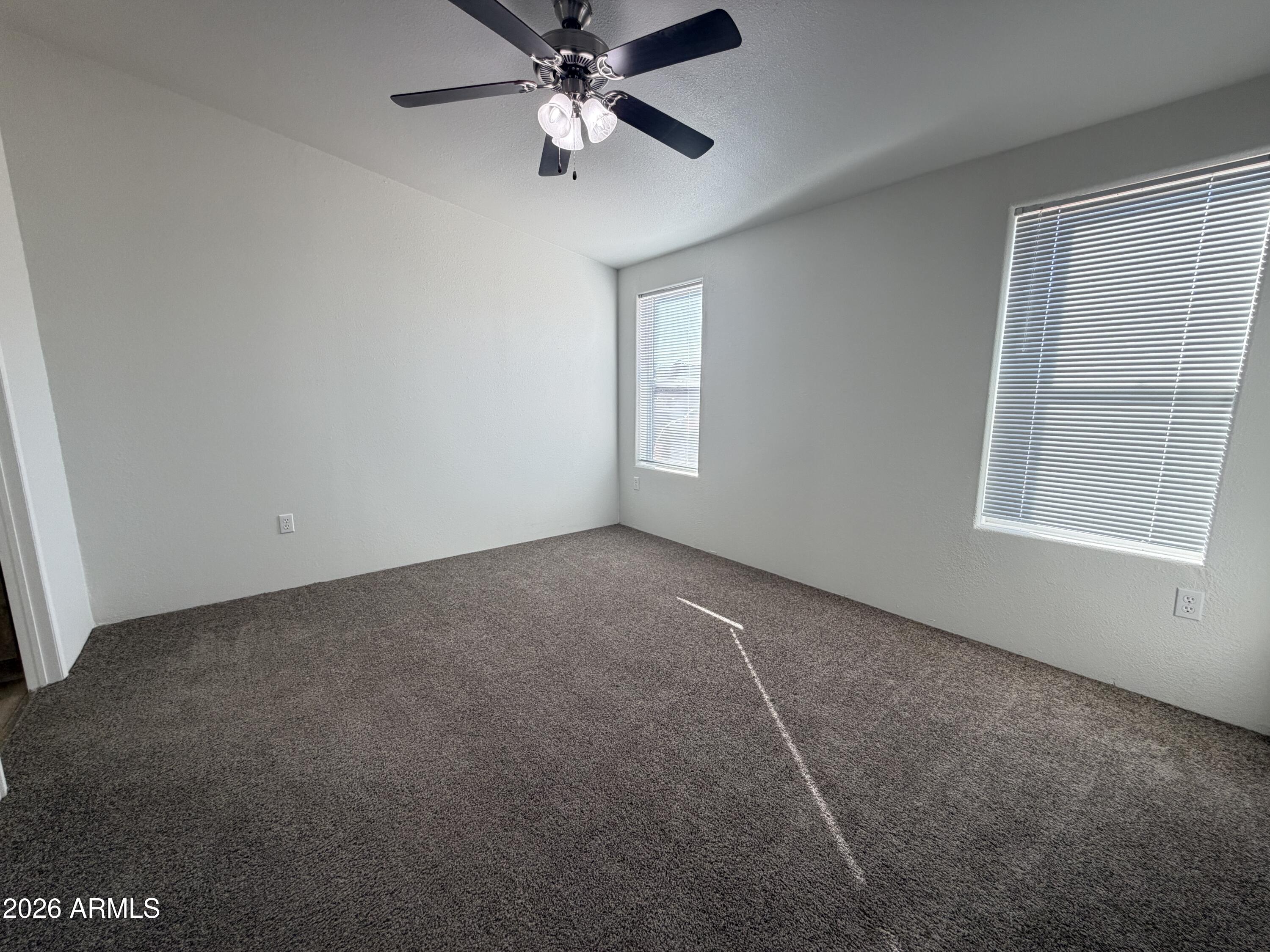 1122 Sheepshead Crossing Road Cornville, AZ 86325 - Photo 12 of 13 an empty room with a window and a fan