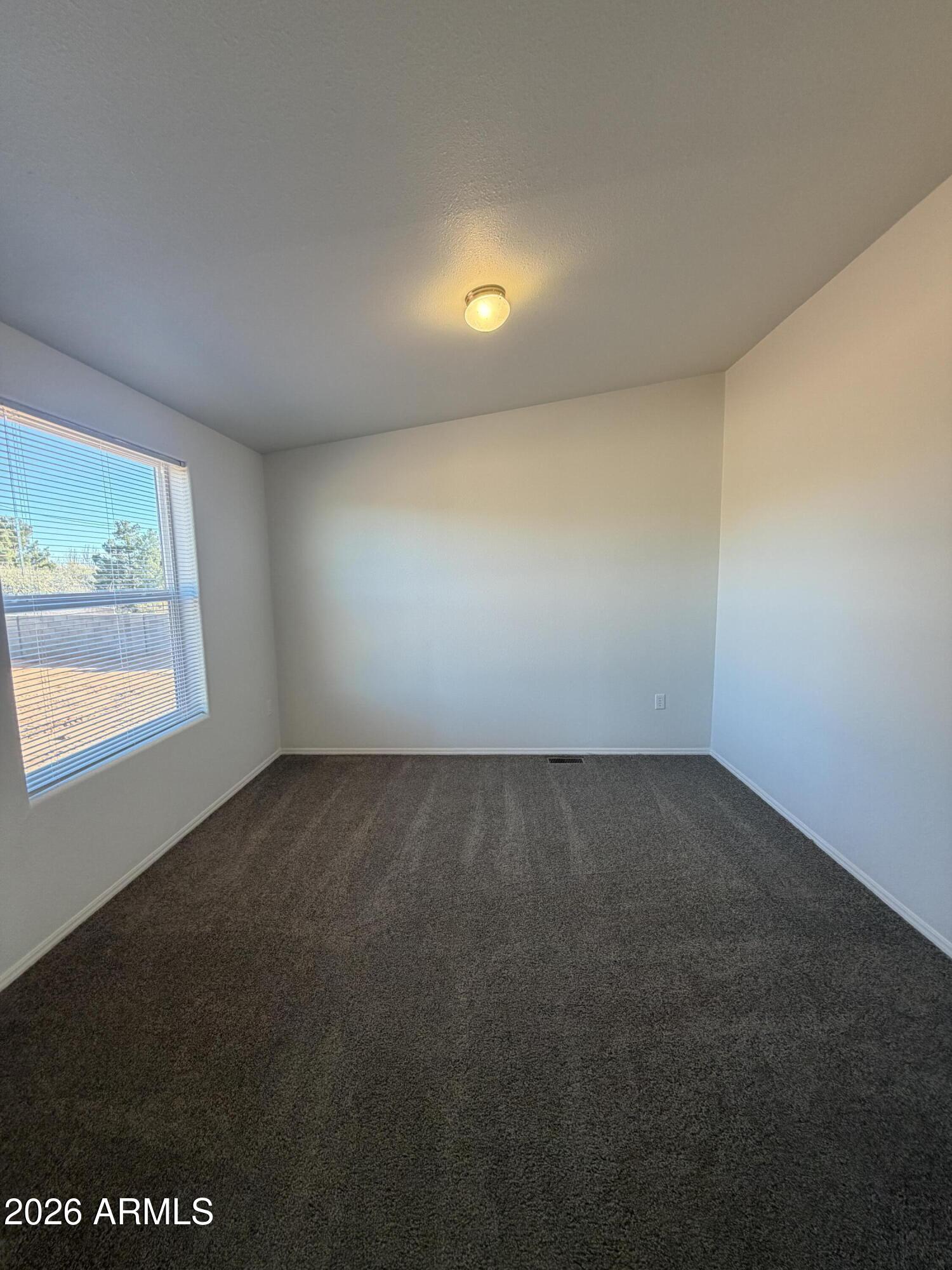 1122 Sheepshead Crossing Road Cornville, AZ 86325 - Photo 3 of 13 an empty room with a empty space and window