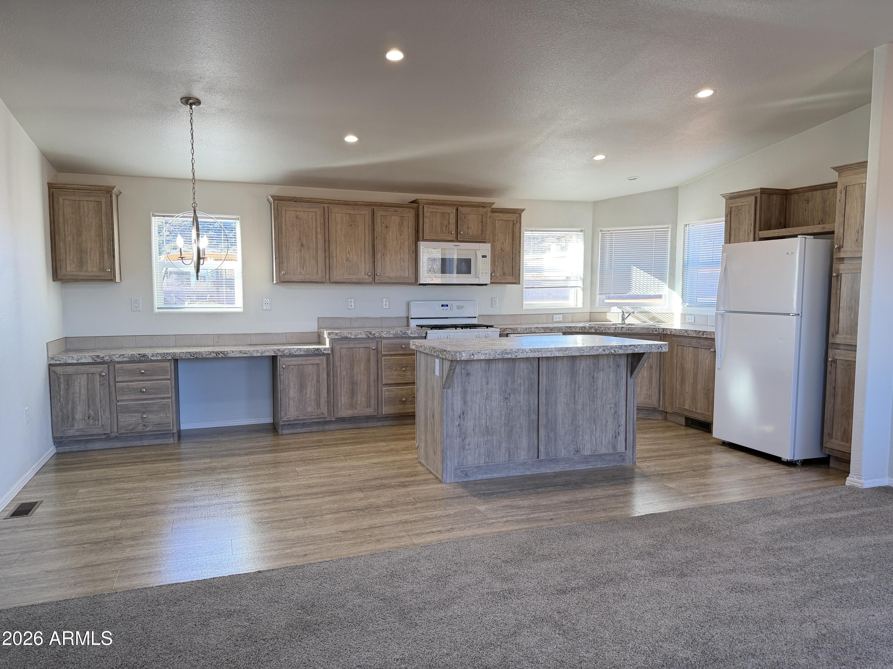 1122 Sheepshead Crossing Road Cornville, AZ 86325 - Photo 5 of 13 a kitchen with stainless steel appliances granite countertop a sink refrigerator and microwave