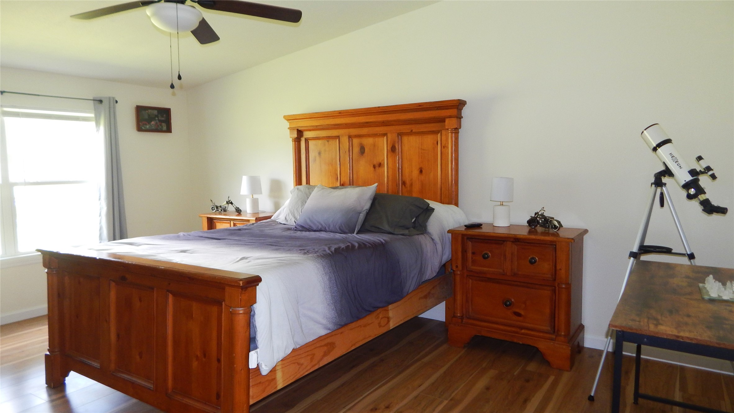 142 County Road 1332 Liberty, TX 77575 - Photo 15 of 50 a bedroom with a bed and wooden floor