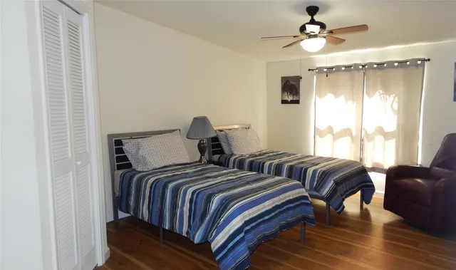 a bedroom with two beds and a window