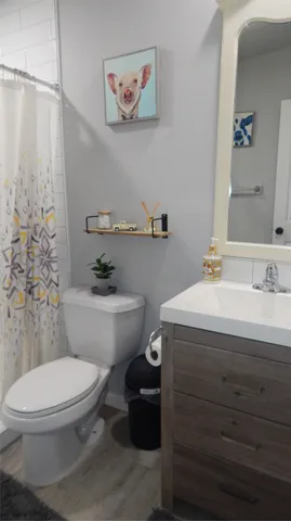 a bathroom with a granite countertop toilet sink and a mirror