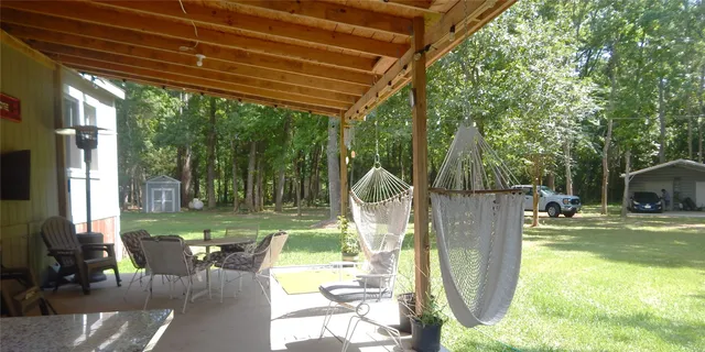 a view of a house with backyard and porch
