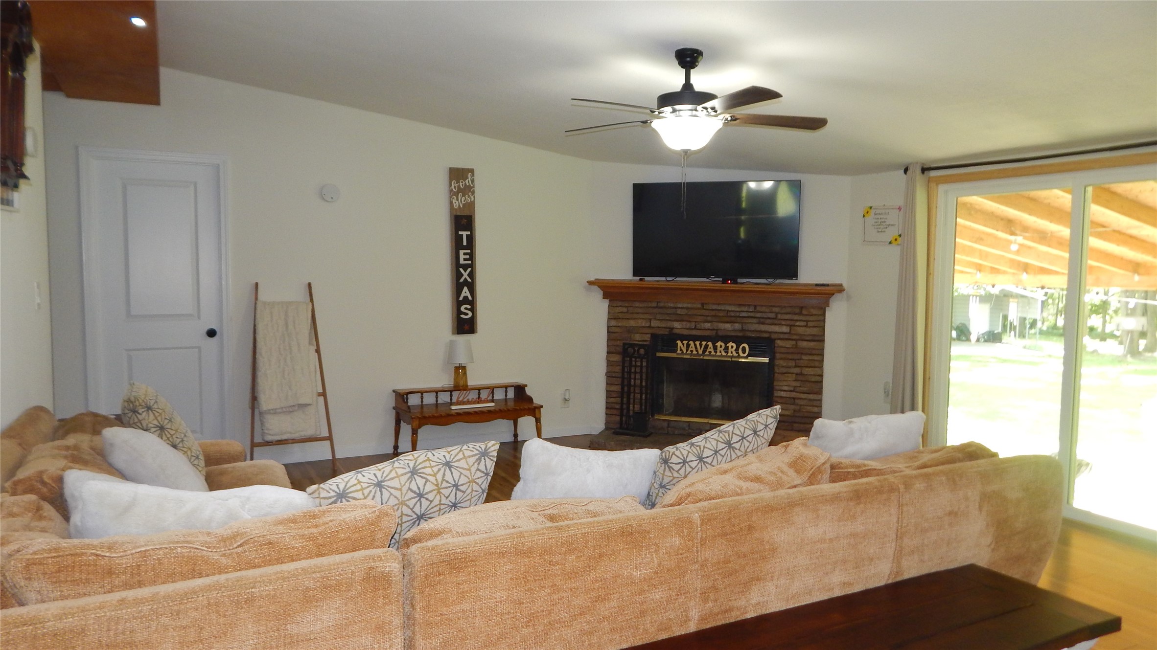 142 County Road 1332 Liberty, TX 77575 - Photo 38 of 50 a living room with furniture a fireplace and a flat screen tv
