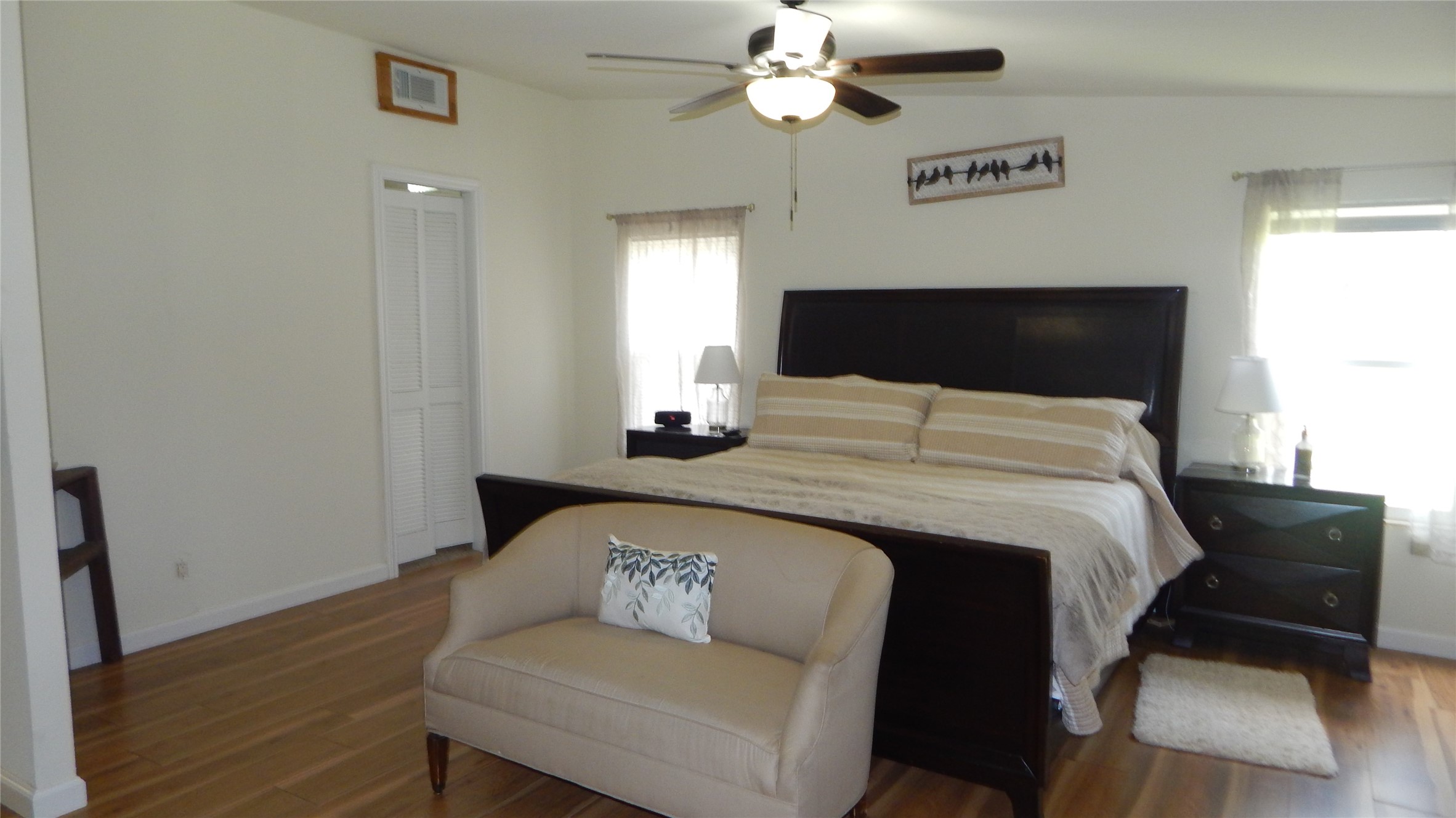 142 County Road 1332 Liberty, TX 77575 - Photo 10 of 50 a bedroom with a bed and wooden floor