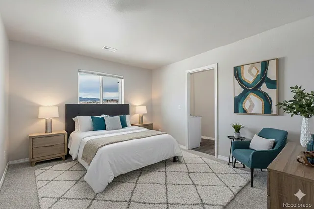 a bedroom with a bed and painting on the wall