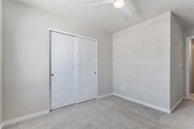 an empty room with closet area