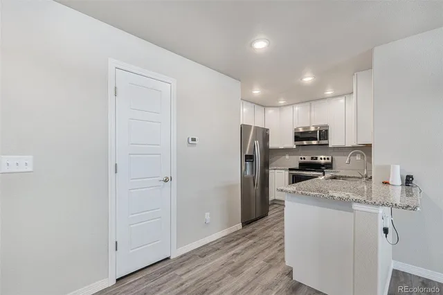 a kitchen with stainless steel appliances a refrigerator stove microwave and sink