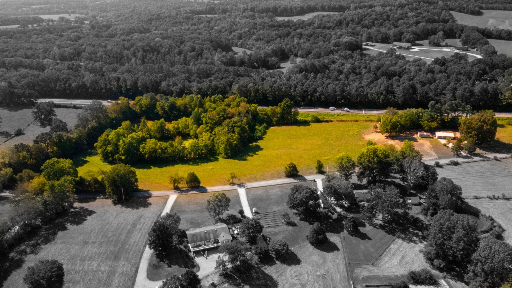 an aerial view of a houses with swimming pool