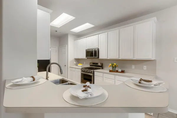 a kitchen with a sink appliances and cabinets