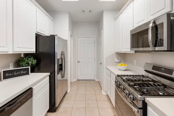 a kitchen with a sink cabinets and appliances