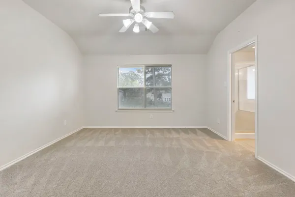 an empty room with windows and cabinet