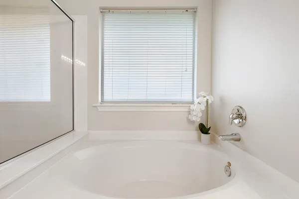 a bathroom with a bathtub sink and mirror