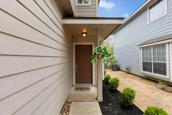 a front view of a house with potted plants