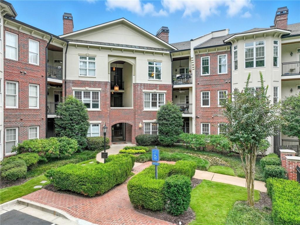825 Highland Lane Northeast, Unit 1312 Atlanta, GA 30306 - Photo 1 of 46 a front view of a house with a yard