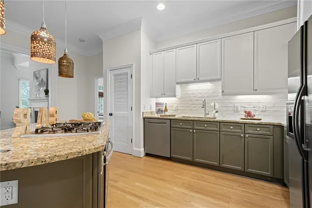 a kitchen with granite countertop cabinets and window