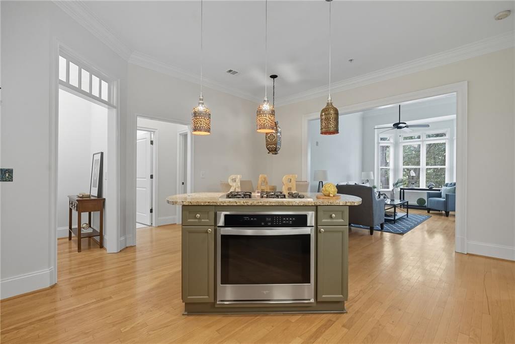 825 Highland Lane Northeast, Unit 1312 Atlanta, GA 30306 - Photo 15 of 46 a kitchen with stainless steel appliances wooden floor and a refrigerator