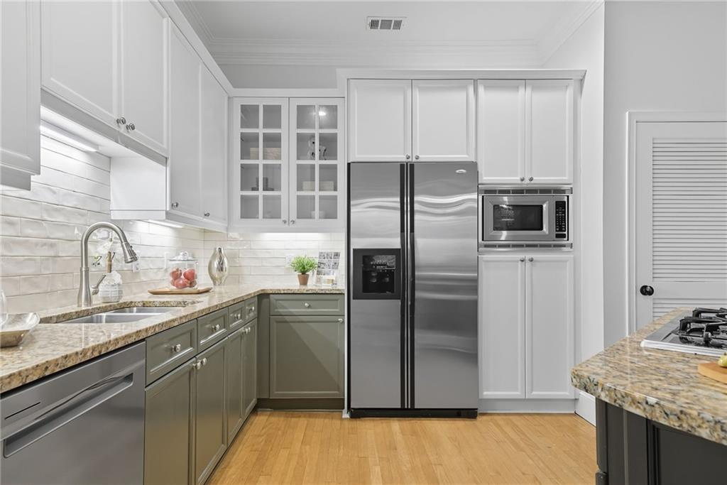 825 Highland Lane Northeast, Unit 1312 Atlanta, GA 30306 - Photo 16 of 46 a kitchen with stainless steel appliances granite countertop a refrigerator and a sink