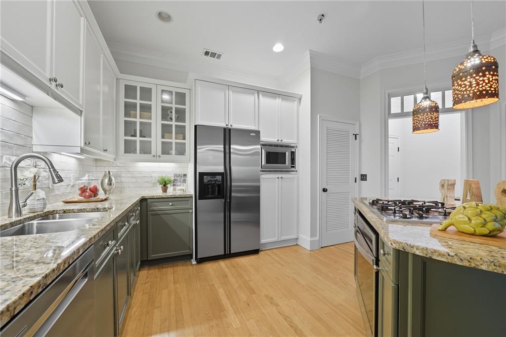 825 Highland Lane Northeast, Unit 1312 Atlanta, GA 30306 - Photo 17 of 46 a kitchen with stainless steel appliances granite countertop a sink stove and refrigerator
