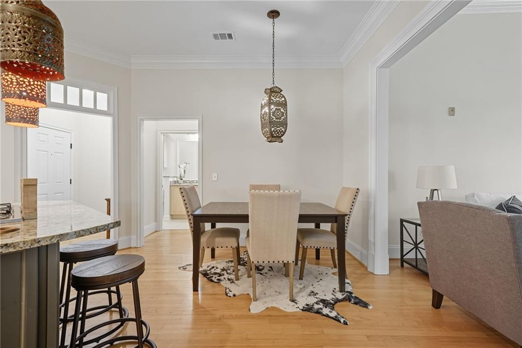 825 Highland Lane Northeast, Unit 1312 Atlanta, GA 30306 - Photo 19 of 46 a view of a dining room with furniture and chandelier