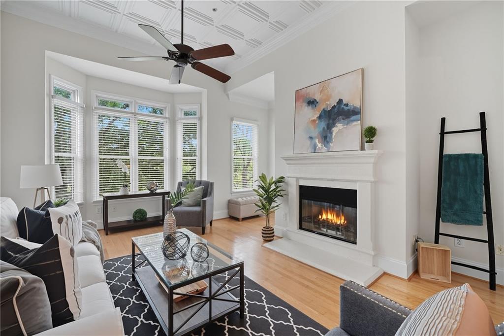 825 Highland Lane Northeast, Unit 1312 Atlanta, GA 30306 - Photo 22 of 46 a living room with furniture a fireplace and a large window