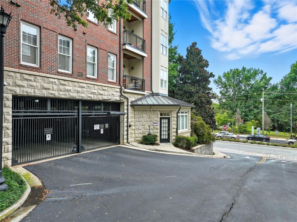 825 Highland Lane Northeast, Unit 1312 Atlanta, GA 30306 - Photo 3 of 46 front view of a brick house with a yard