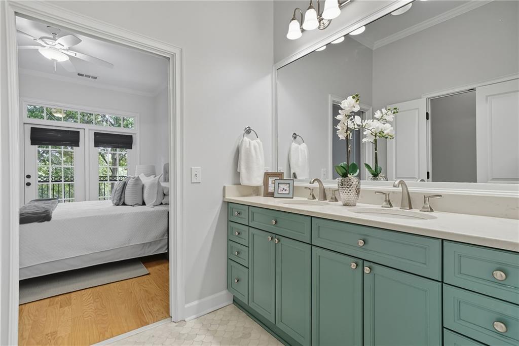 825 Highland Lane Northeast, Unit 1312 Atlanta, GA 30306 - Photo 31 of 46 a en suite bathroom with a double vanity sink and a mirror