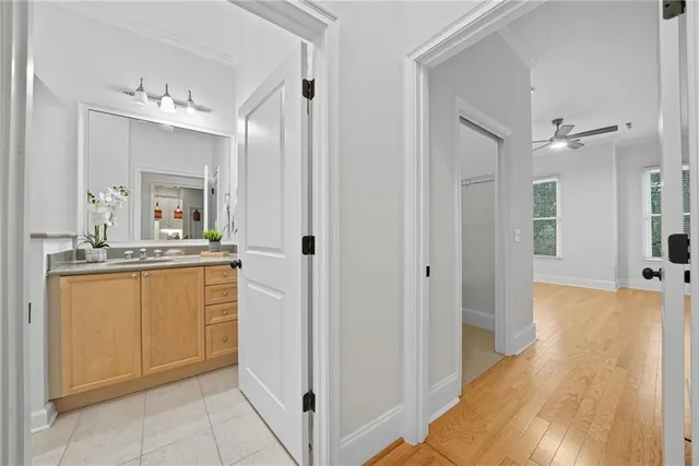 a bathroom with a granite countertop sink toilet a large mirror a shower and a bathtub