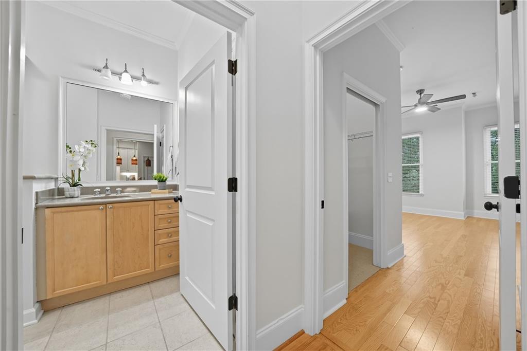 825 Highland Lane Northeast, Unit 1312 Atlanta, GA 30306 - Photo 33 of 46 a bathroom with a sink a mirror and a shower