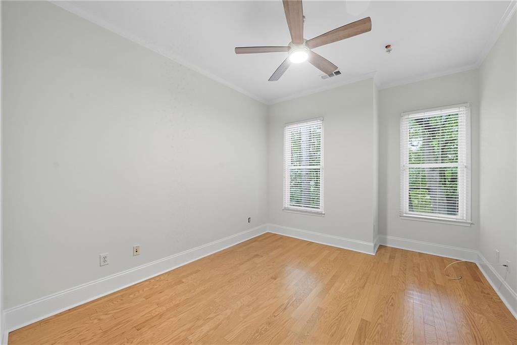 825 Highland Lane Northeast, Unit 1312 Atlanta, GA 30306 - Photo 35 of 46 an empty room with a window and a ceiling fan