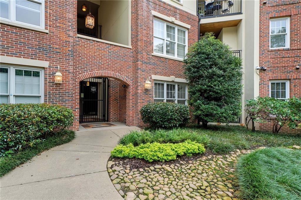 825 Highland Lane Northeast, Unit 1312 Atlanta, GA 30306 - Photo 40 of 46 a front view of a house with garden