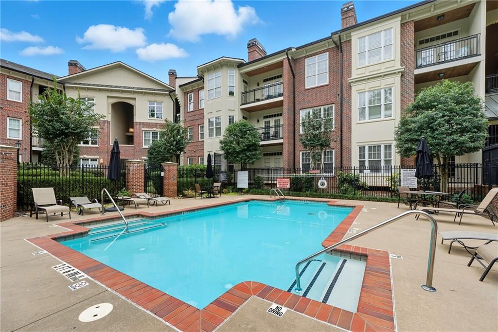 825 Highland Lane Northeast, Unit 1312 Atlanta, GA 30306 - Photo 42 of 46 a front view of house with yard and swimming pool
