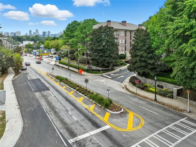 a view of a swimming pool with a patio and a yard