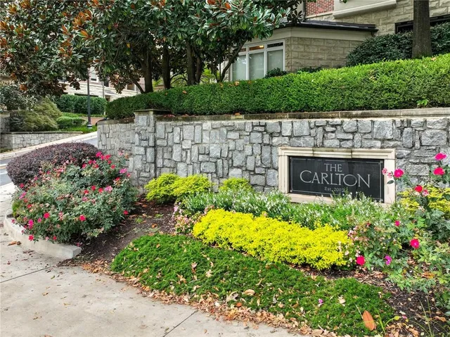 a view of garden with flowers and trees