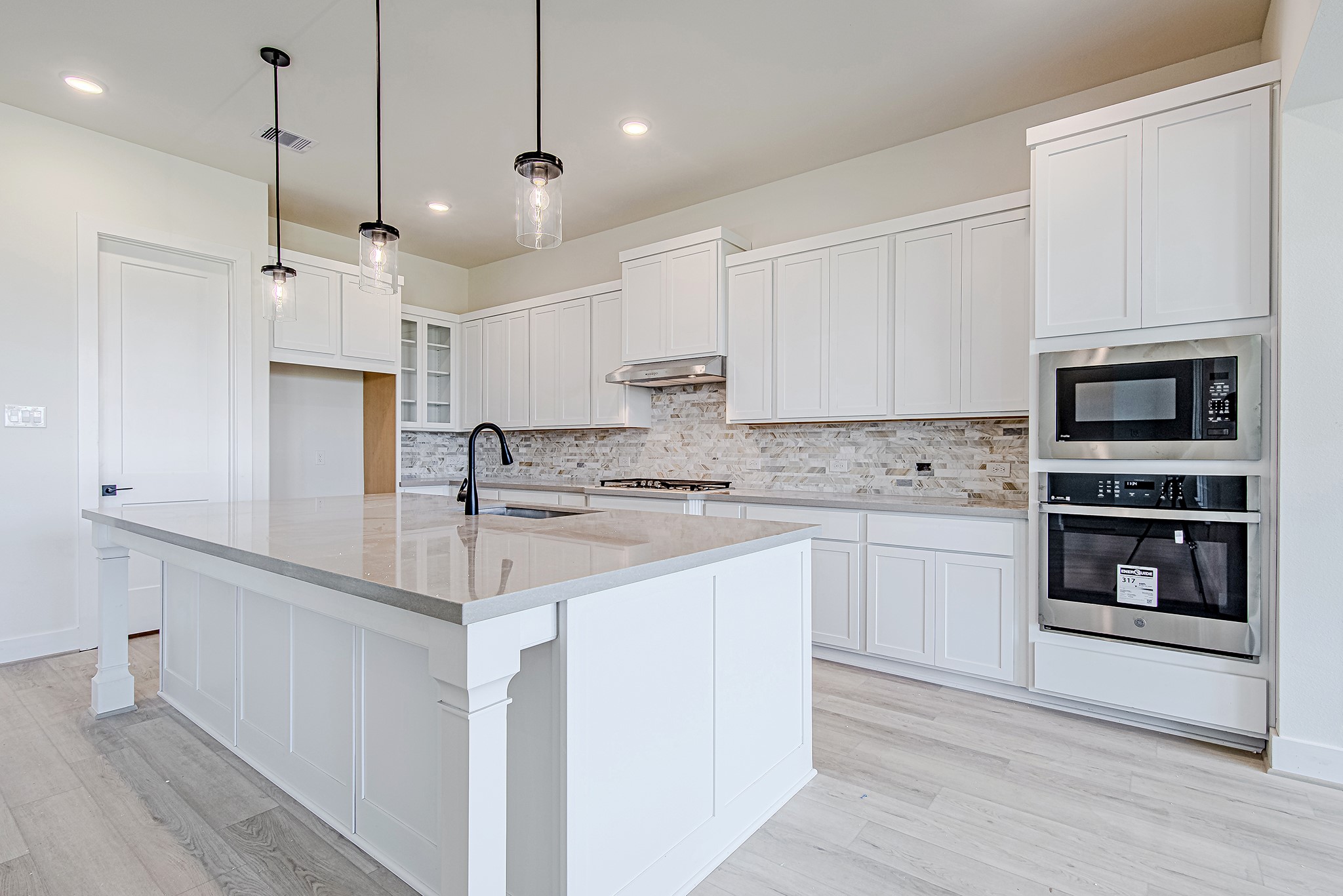 153 Peninsula Point Drive Montgomery, TX 77356 - Photo 11 of 46 Built-in stainless steel appliances and ample counter space highlight this modern kitchen