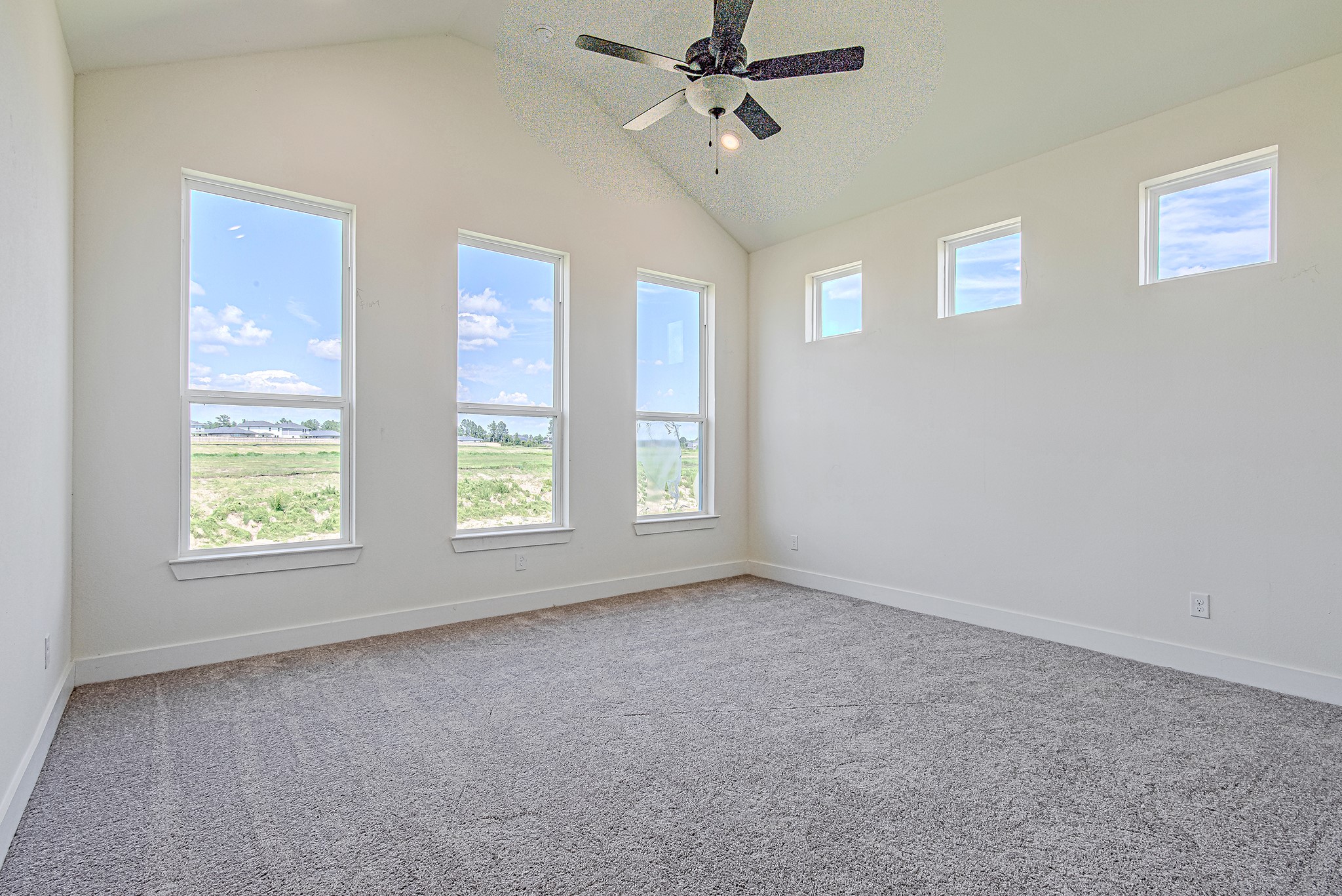 153 Peninsula Point Drive Montgomery, TX 77356 - Photo 18 of 46 The primary suite offers large windows, a ceiling fan, and serene backyard views