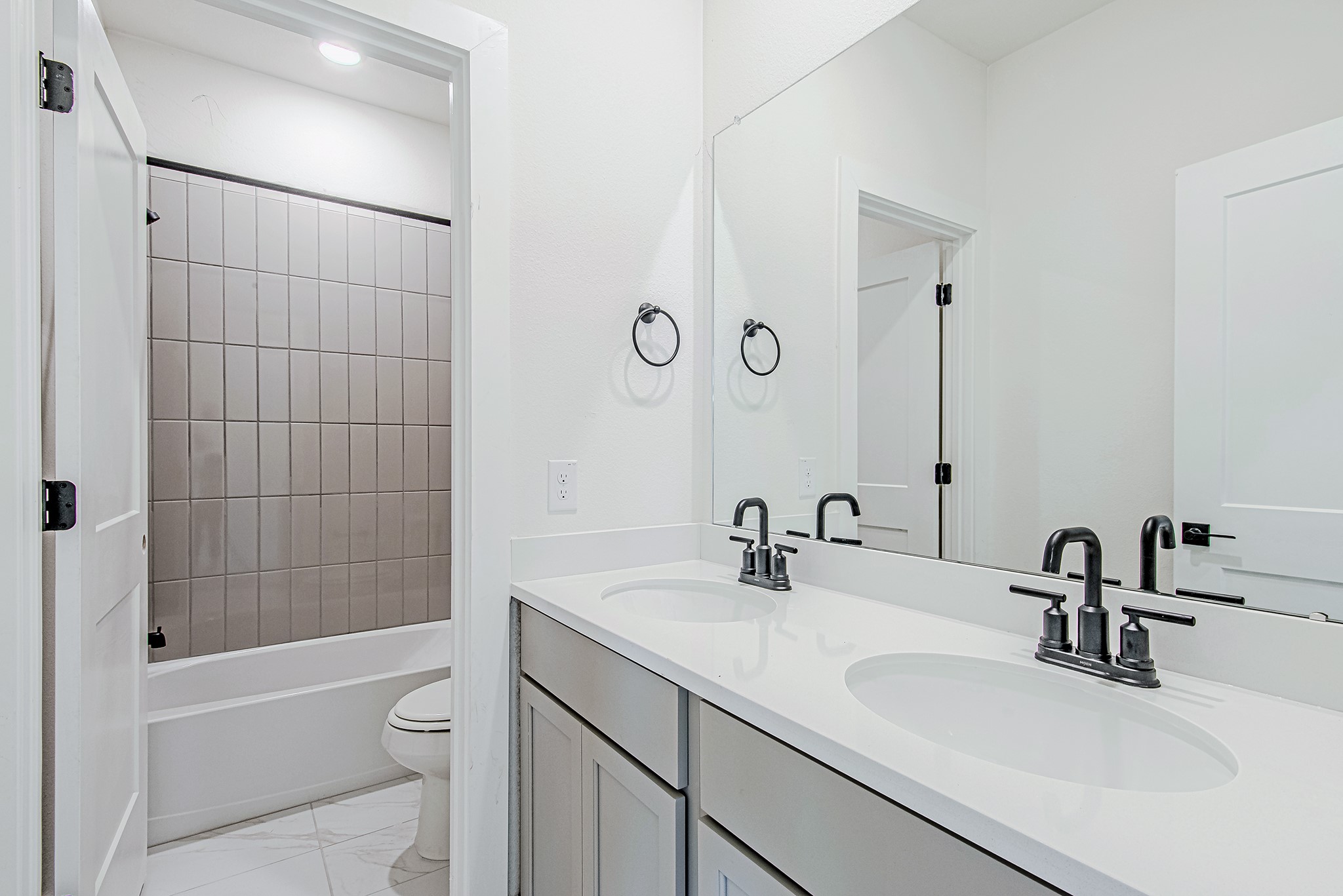 153 Peninsula Point Drive Montgomery, TX 77356 - Photo 35 of 46 Secondary bathroom with a dual vanity and sleek tiled shower