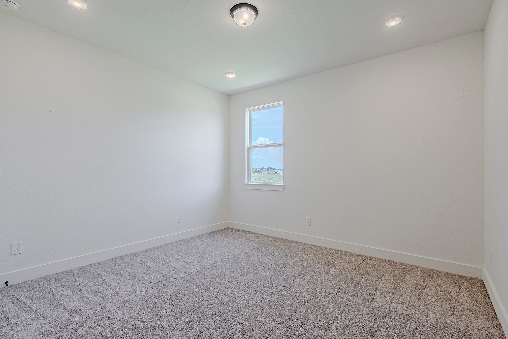153 Peninsula Point Drive Montgomery, TX 77356 - Photo 36 of 46 Another sunlit secondary bedroom with soft carpet and neutral tones