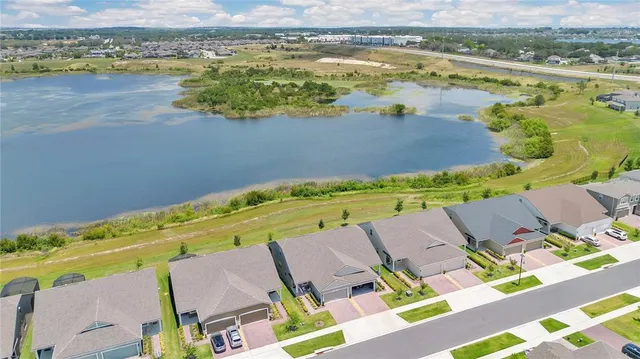 an aerial view of a house with a lake view