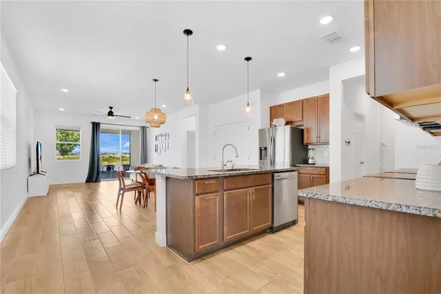 a large kitchen with lots of counter space and furniture